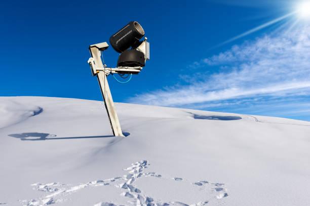 Snow cannon or snowmaking system on a winter landscape with powder snow, Italian Alps, Italy, Europe.