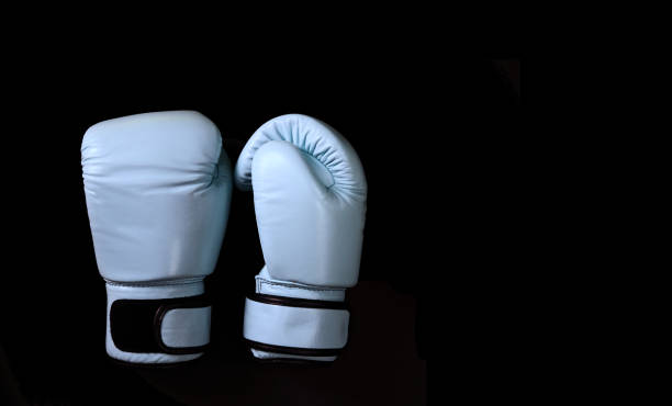 istock Blue boxing gloves in sport on black 1388737396