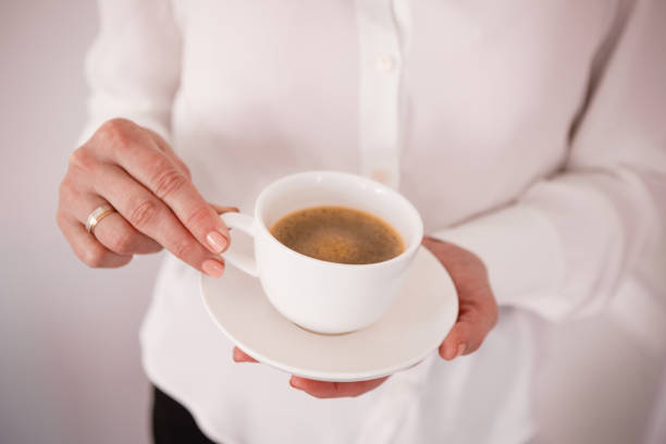 istock Business meeting with coffee in hand. White cup with black coffee. 1388739509