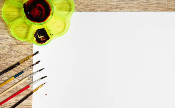 istock paint brush on paper with pallette color 1388740860
