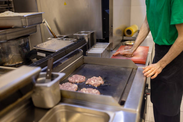 istock Unrecognizable chef, grill the burger patty in the kitchen 1388741140