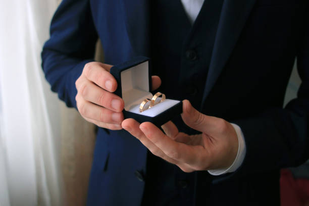 istock wedding rings in boxes in the hands 1388741397