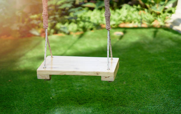 istock swing in playground with sun 1388742350