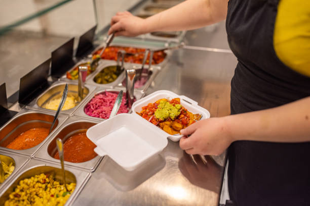 istock Unrecognizable female fast food worker, making burrito 1388742516