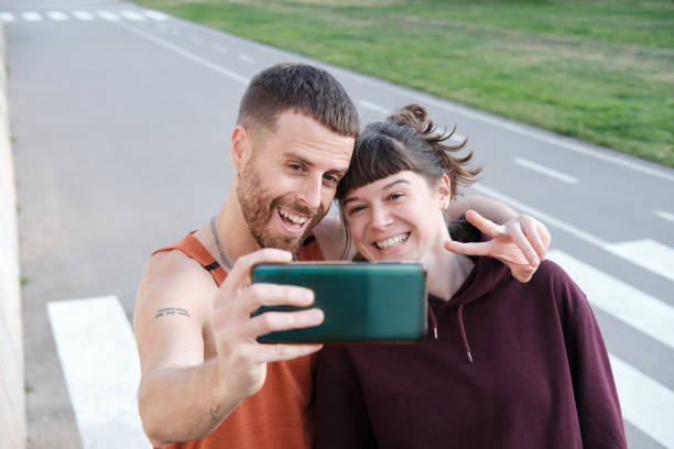 istock Two friends take a selfie in a city. 1388742542