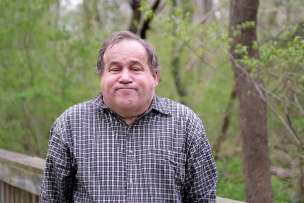 istock Disabled Autistic man posing for a portrait outdoors during the day. 1388742617