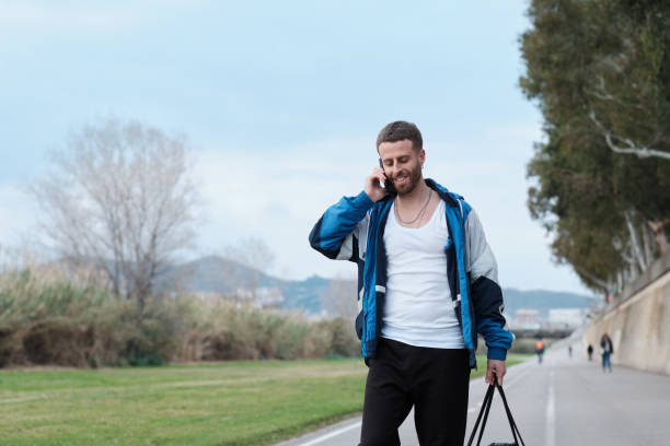 istock One young trendy person uses a cell phone. 1388742637