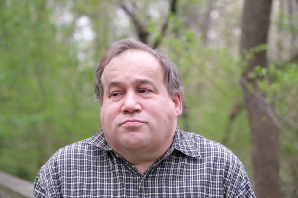 istock Autistic man portrait outdoors in a rural background 1388742887