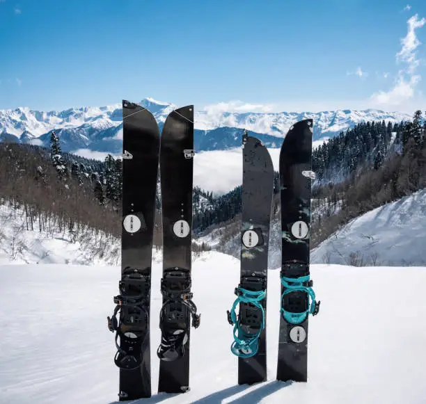 Splitboards in snow at winter mountains background. Sport equipment for ski touring