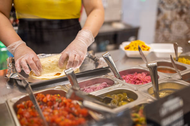 istock Unrecognizable Caucasian female fast food worker, making burrito 1388743007