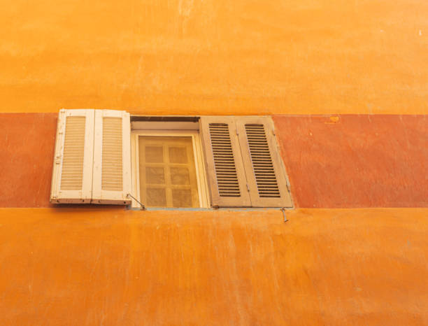 istock Window in an old orange wall background. 1388743568