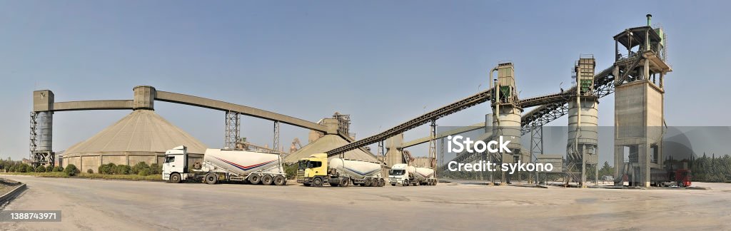 Panoramic view of cement factory Cement factory's yard with lories and silos Cement Stock Photo