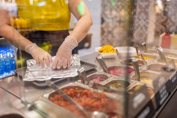 istock Unrecognizable Caucasian female fast food worker, making burrito 1388744351