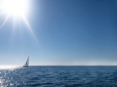 Barquentine with white sails in the calm sea