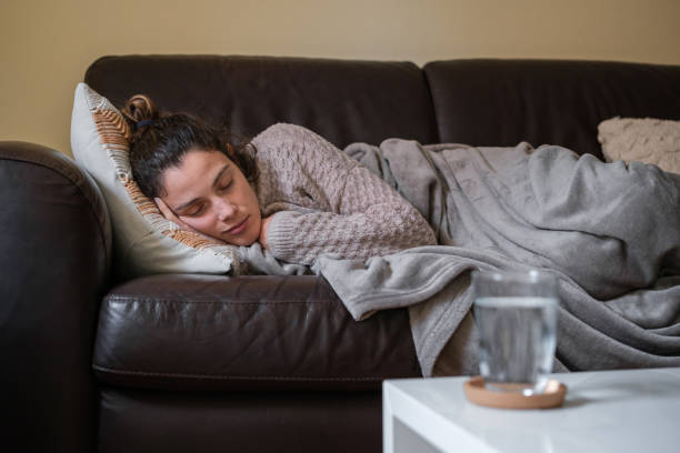 istock Ill woman asleep on the couch. 1388745181