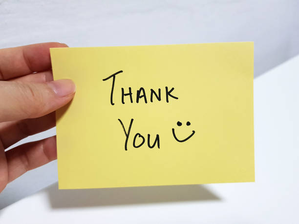 istock A person holding a Thank You note with a smiling face 1388745867
