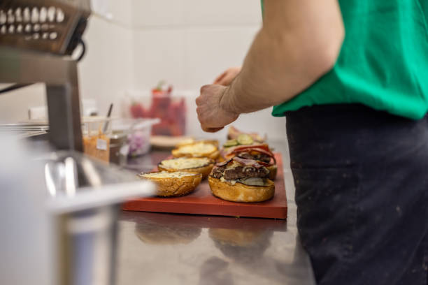 istock Unrecognizable chef, making the burger at the fast food restaurant kitchen 1388746610