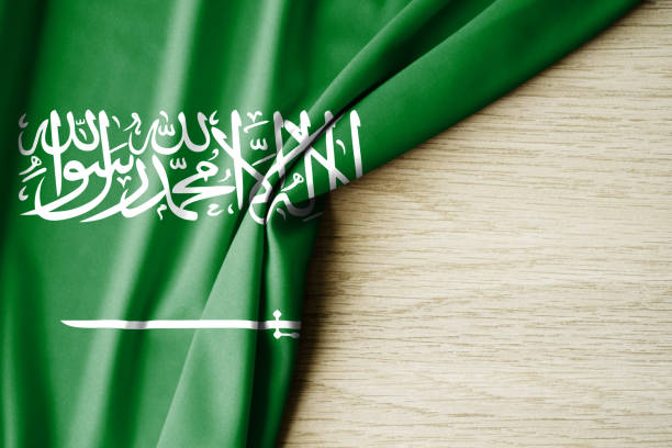 istock Saudi Arabia flag. Fabric pattern flag of Saudi Arabia. 3d illustration. with back space for text. 1388746747
