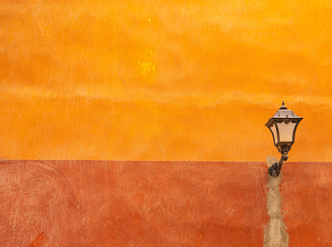 Old street lantern on orange