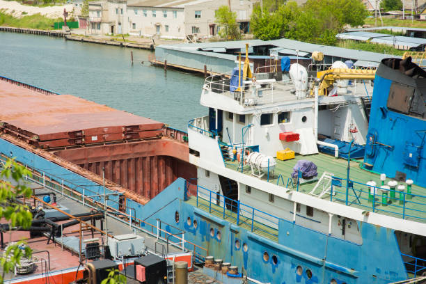 dry cargo ship moored in the port with an open hatch for loading