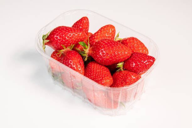 istock Punnet of strawberries isolated on white background 1388750441