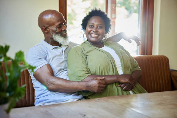 istock Mature couple smiling while sitting together in a cafe 1388752305