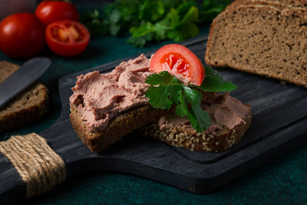 istock Liver meat pate spread on rye bread, breakfast, close-up, dark background. no people, selective focus, 1388752713