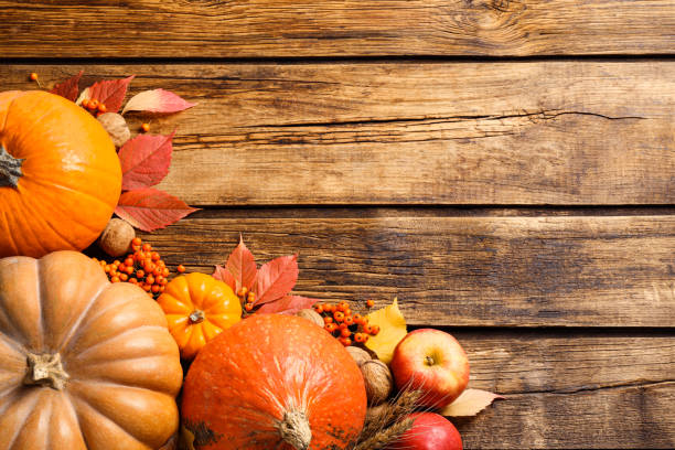 istock Flat lay composition with ripe pumpkins and autumn leaves on wooden table, space for text. Happy Thanksgiving day 1388753974