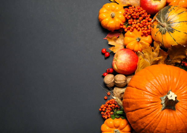 istock Flat lay composition with ripe pumpkins and autumn leaves on black background, space for text. Happy Thanksgiving day 1388754290