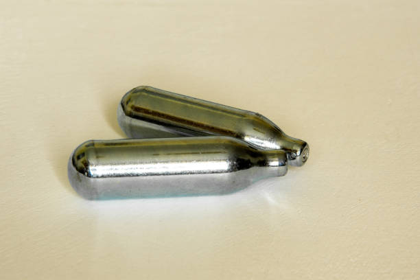istock Pair of Nitrous oxide or laughing gas canisters isolated 1388755876