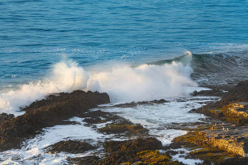 VIew from above of a wave breaking in the coast of Pichilemu, Chile