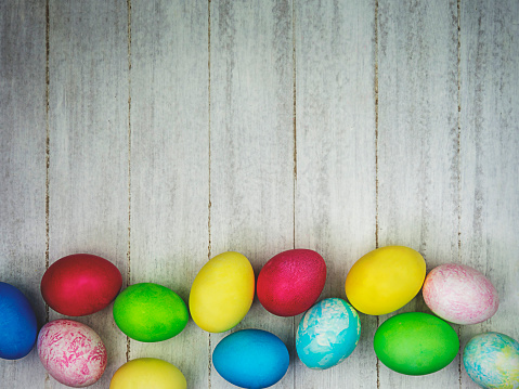 Multicolored painted eggs on a gray background. Easter concept
