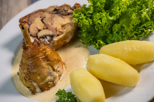 Chicken gigolette recipe with mushrooms accompanied by turned potatoes and salad, creamy sauce, High quality photo