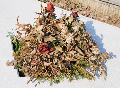Withered wreath in the public cemetery