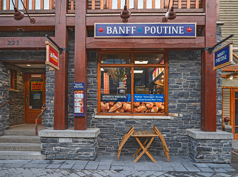 Banff, Alberta, Canada – March 30, 2022:  Exterior view of “Banff Poutine” fast food restaurant in downtown