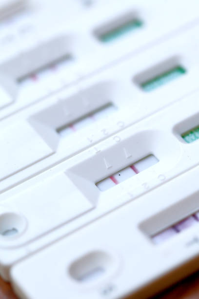 istock Antigen Test kit with Positive result during swab COVID-19 testing. Coronavirus Self nasal or Home test, Lockdown and Home Isolation concept. 1388767583