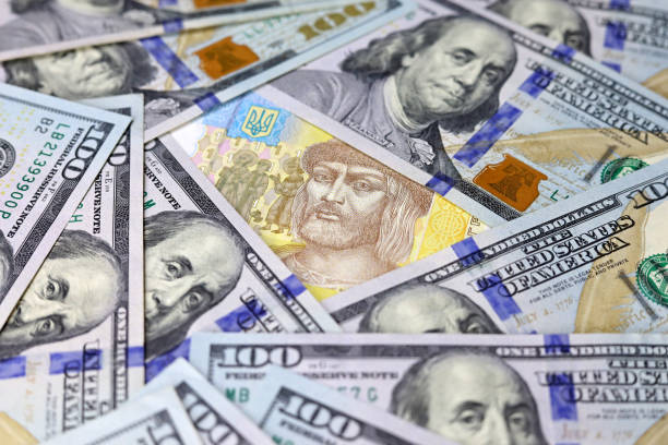 Ukrainian hryvnia surrounded by US dollars banknotes Concept of american assistance for Ukraine, exchange rate ukrainian currency stock pictures, royalty-free photos & images