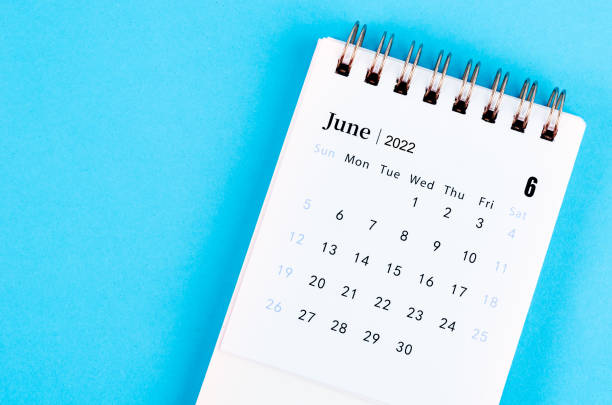 istock June 2022 desk calendar on blue background. 1388770685