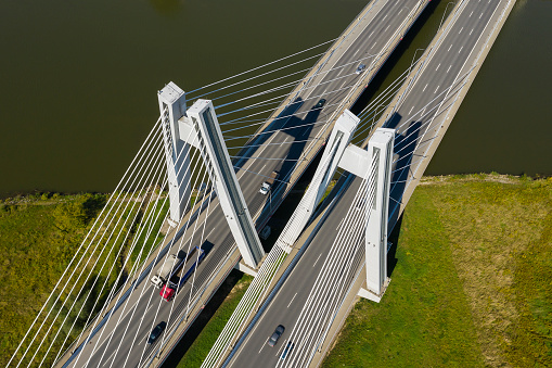 Aerial view of the suspension bridge with traffic over the river in the summer, landscape in Germany.