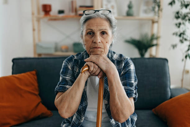 istock Senior woman with walking stick 1388772152