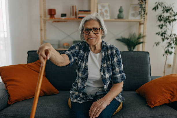 istock Senior woman with walking stick 1388772153
