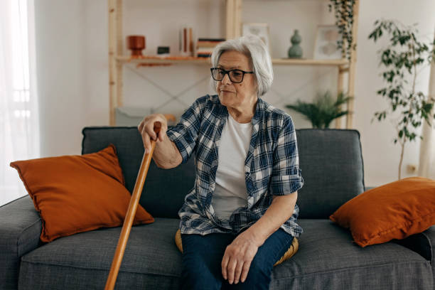 istock Senior woman with walking stick 1388772156