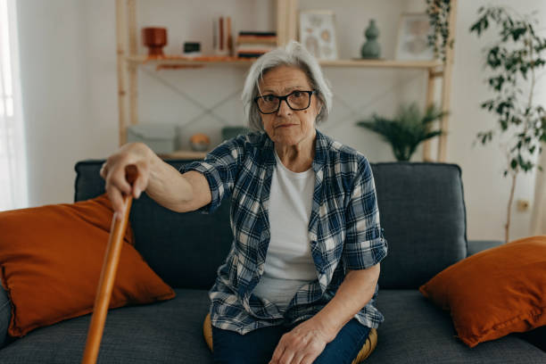 istock Senior woman with walking stick 1388772172