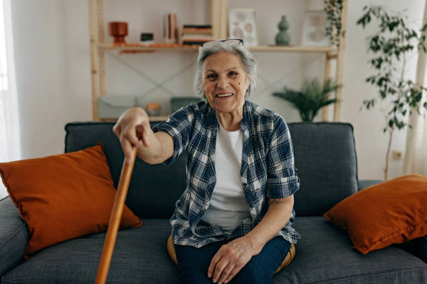 istock Senior woman with walking stick 1388772182