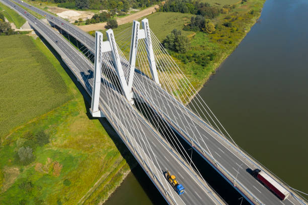istock Aerial View of White Cable-Stayed Bridge over River with Traffic 1388772232