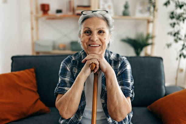 istock Senior woman with walking stick 1388772236
