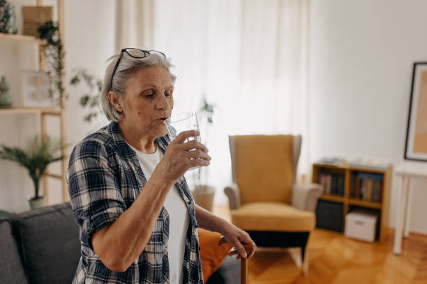 istock Thirsty senior woman 1388772297