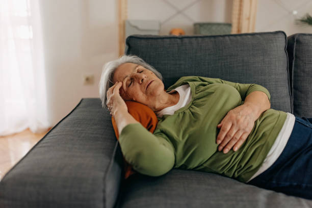 istock Lying on the sofa with stomach pain 1388772641