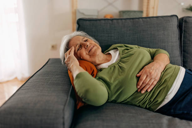istock Lying on the sofa with stomach pain 1388772702