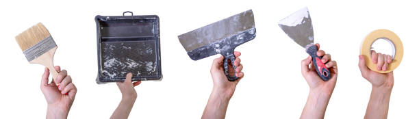 istock Hands of handyman with tools. House renovation and construction. 1388774305